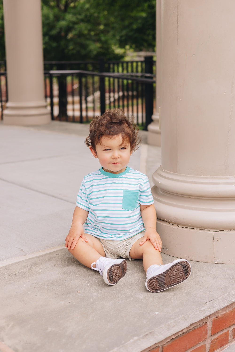 baby boy wearing green strip UPF tee and adventure short in khaki