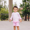 Little girl wearing pink gingham UPF 50+ top and girl shorties